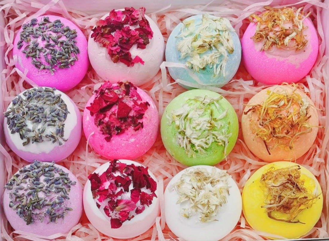 A box filled with vibrant, colorful bath bombs labeled 'Salt Ball' in various shapes and sizes.