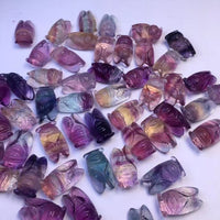 A vibrant assortment of colorful glass beads, showcasing natural fluorite raw stone pendant accessories.