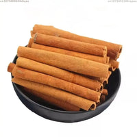 A black bowl containing cinnamon sticks on a white background, ideal for crafting scented soaps and candles.